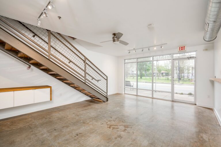 Ground-floor view toward the glass storefront at 1601 E Cesar Chavez St, Unit 104, Austin, TX 78702
